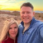 A man and woman standing in the desert.