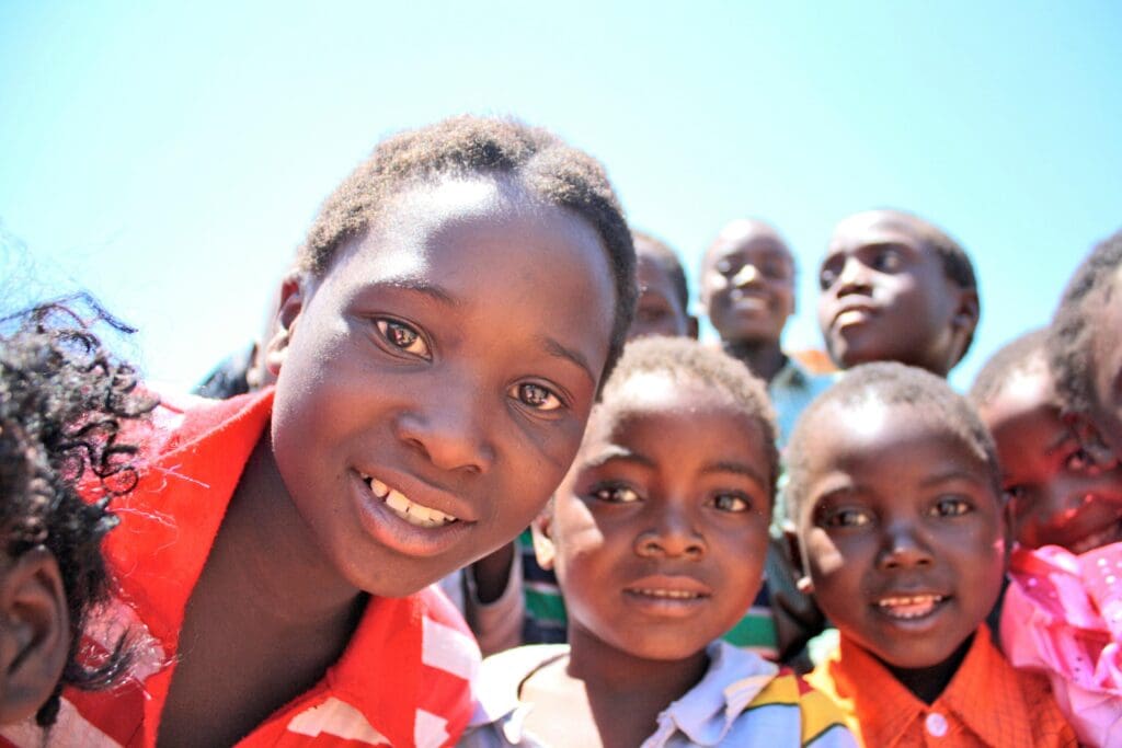 A group of children standing together in front of the camera.