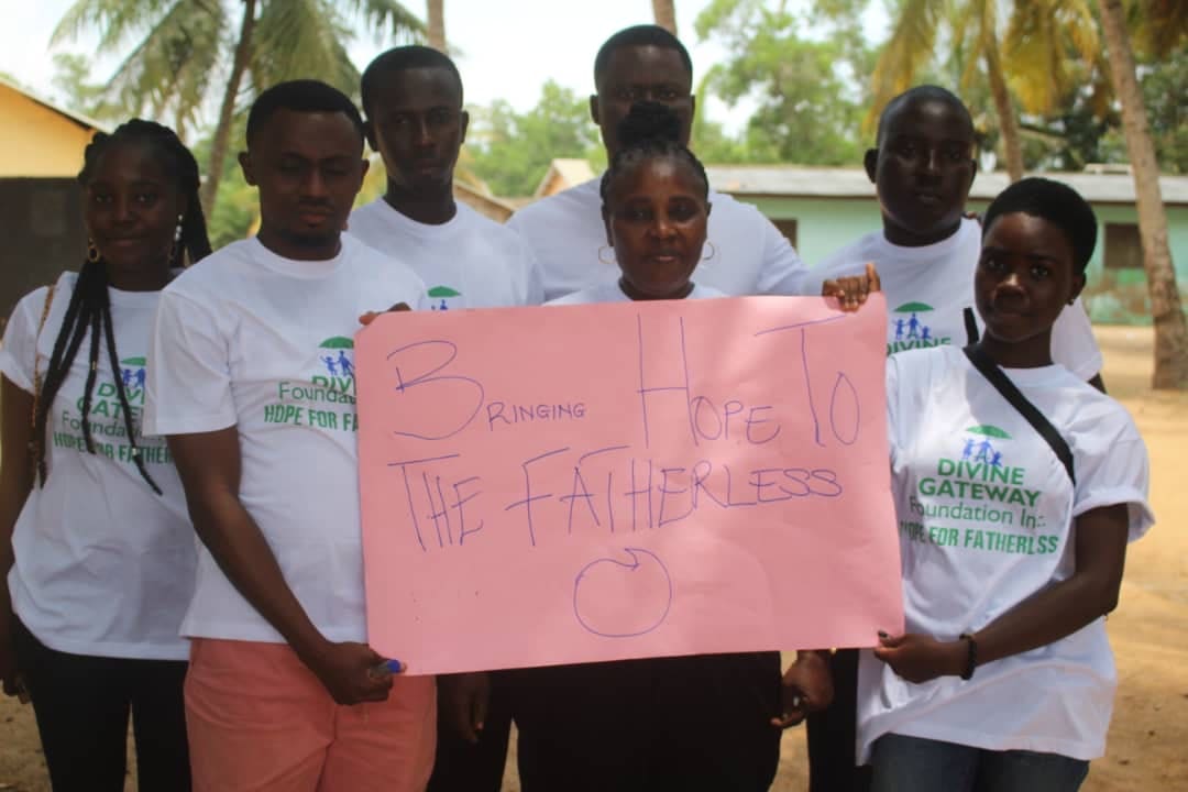 A group of people holding up a sign.