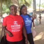 Two women standing next to each other on a beach.