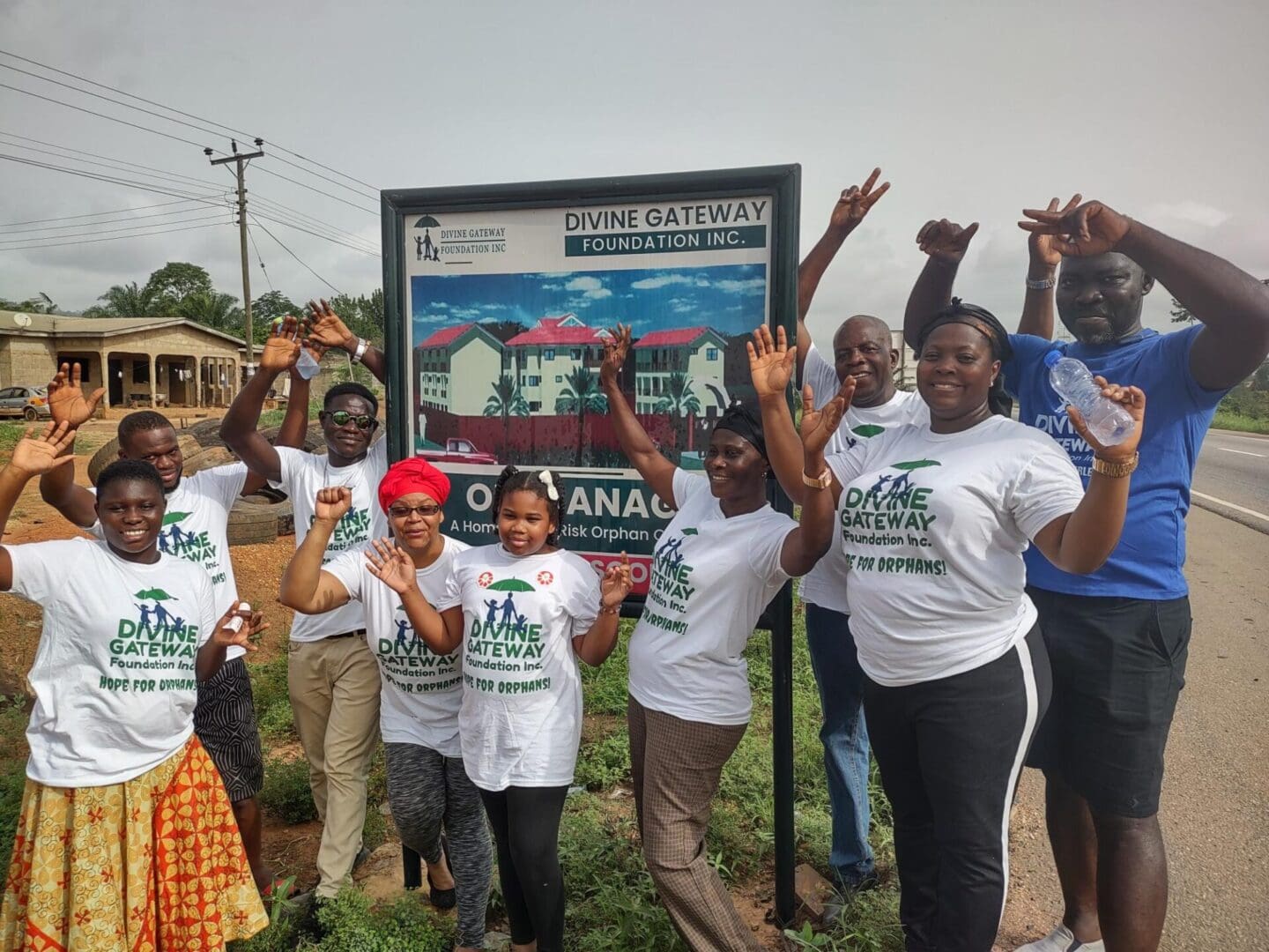 A group of people standing in front of a sign.