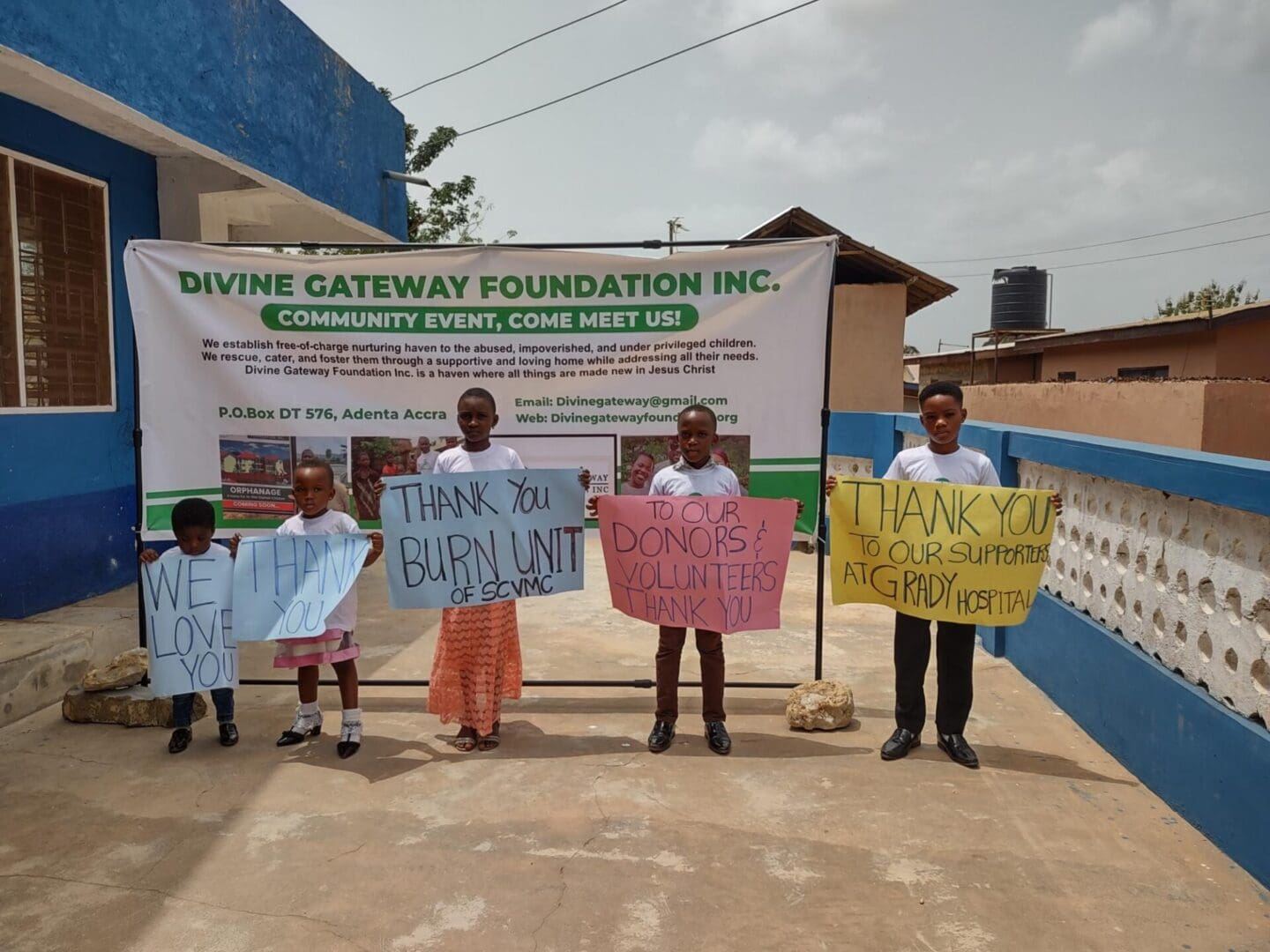 A group of people holding signs in front of a sign.