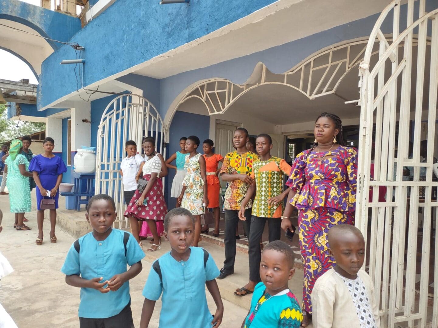 A group of people standing outside of a building.