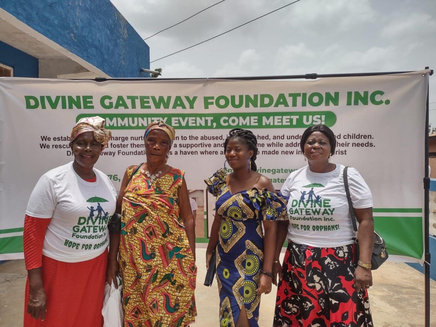 Four women standing in front of a sign.