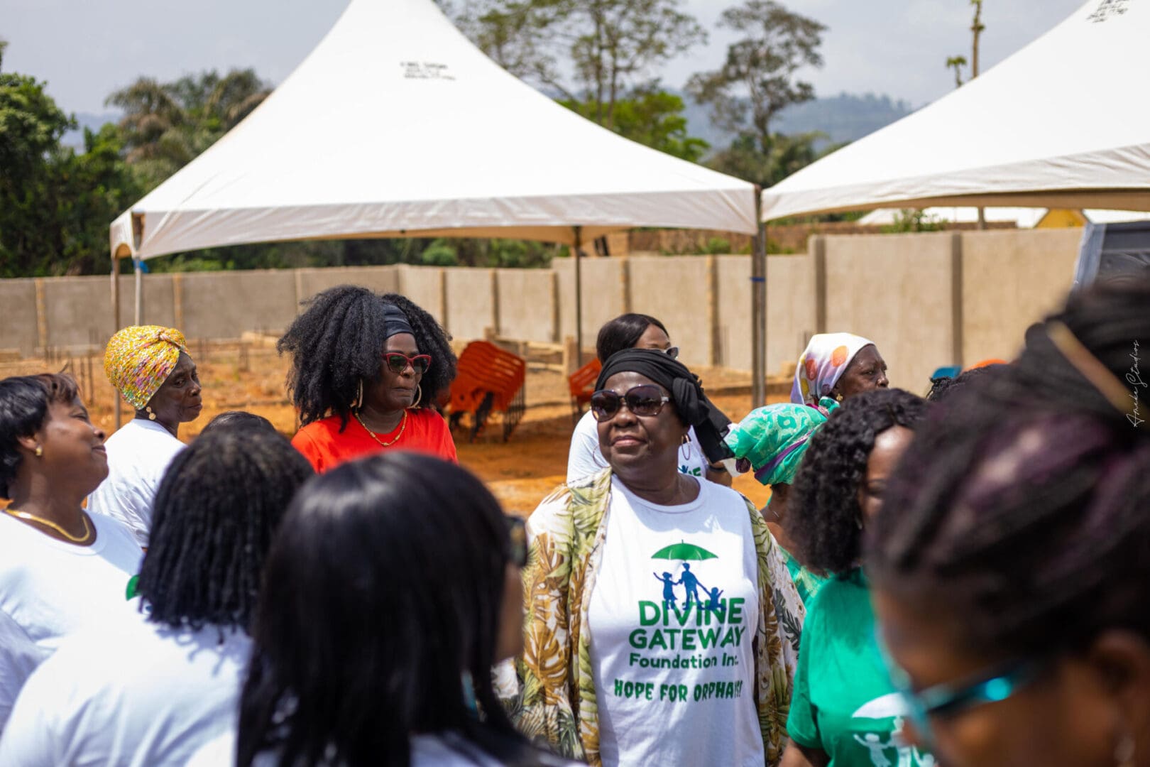 A group of people standing around in front of tents.