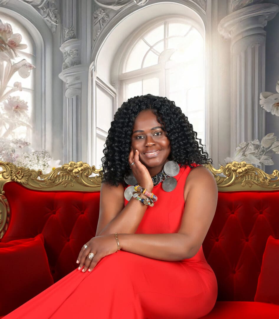 A woman sitting on top of a red couch.