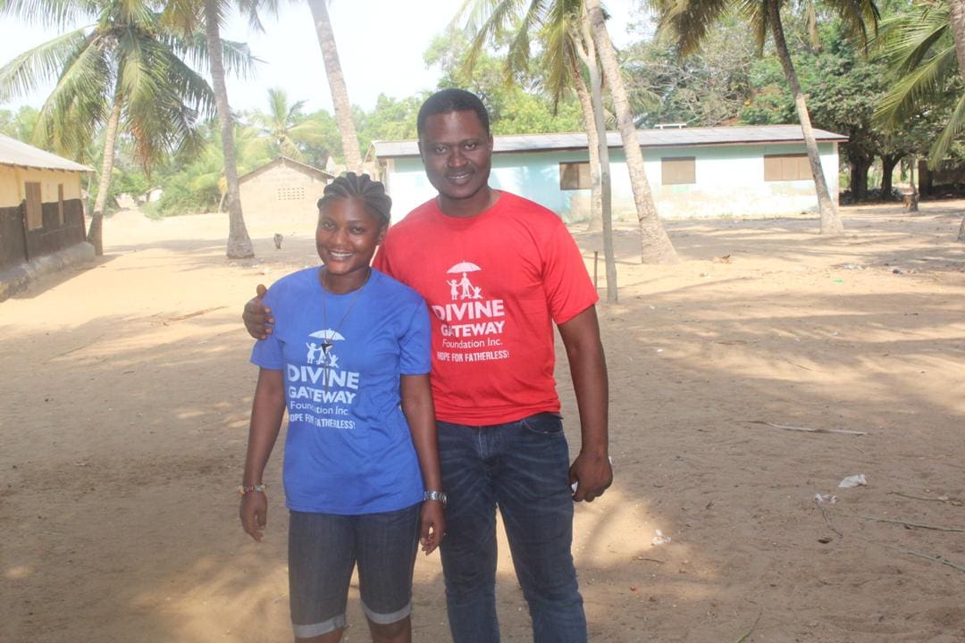 A man and woman standing in the sand.