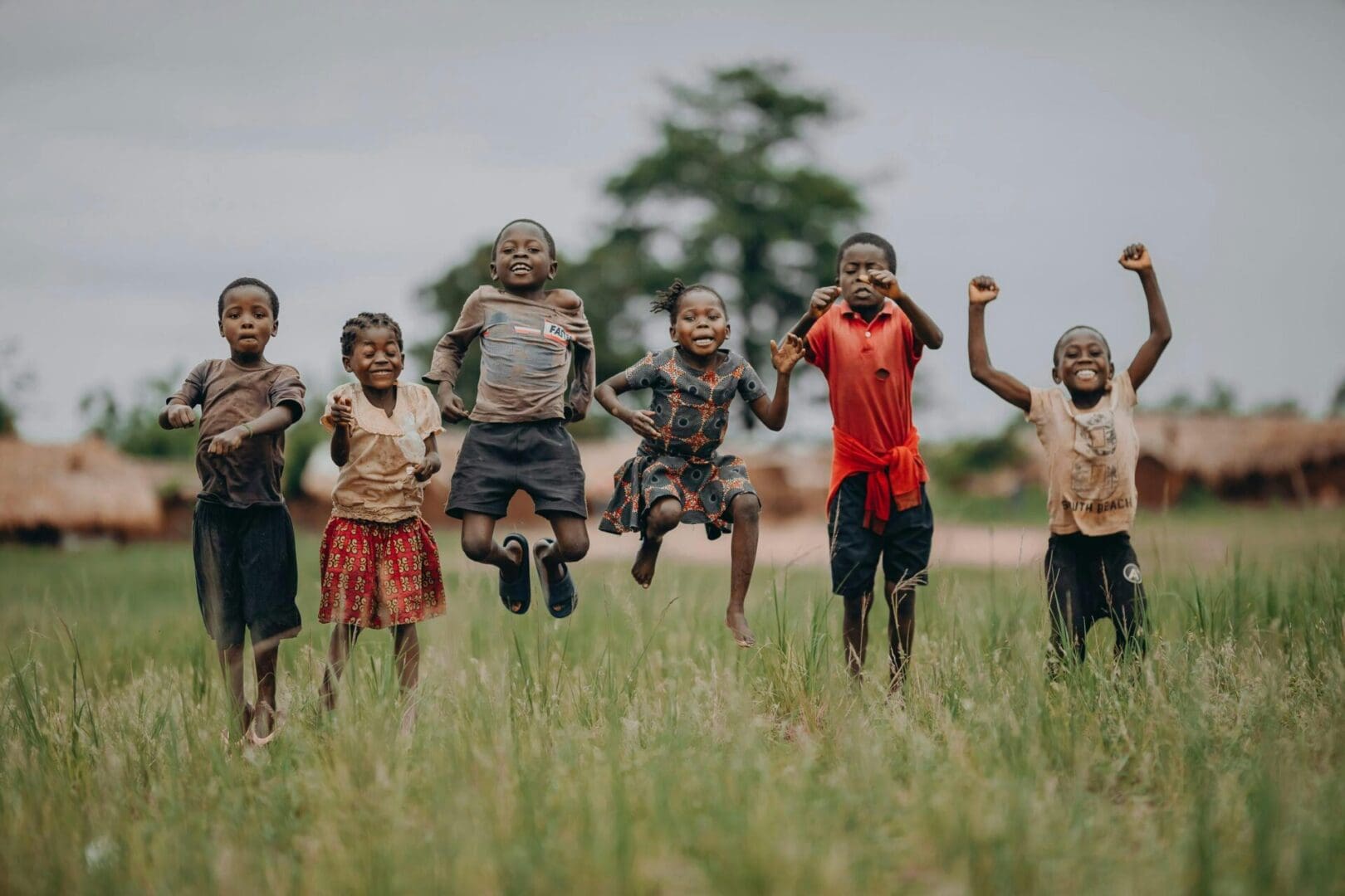 A group of children jumping in the air.