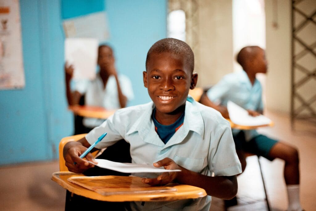 A boy sitting at his desk in front of some papers.