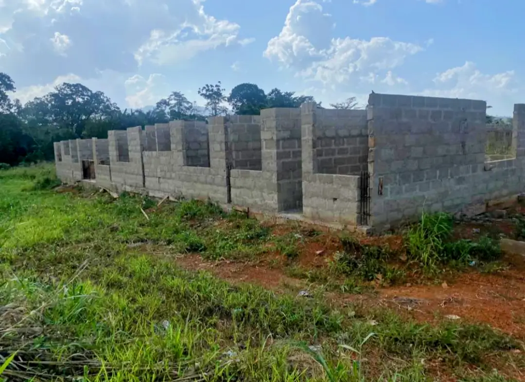 A wall of concrete blocks in the middle of a field.